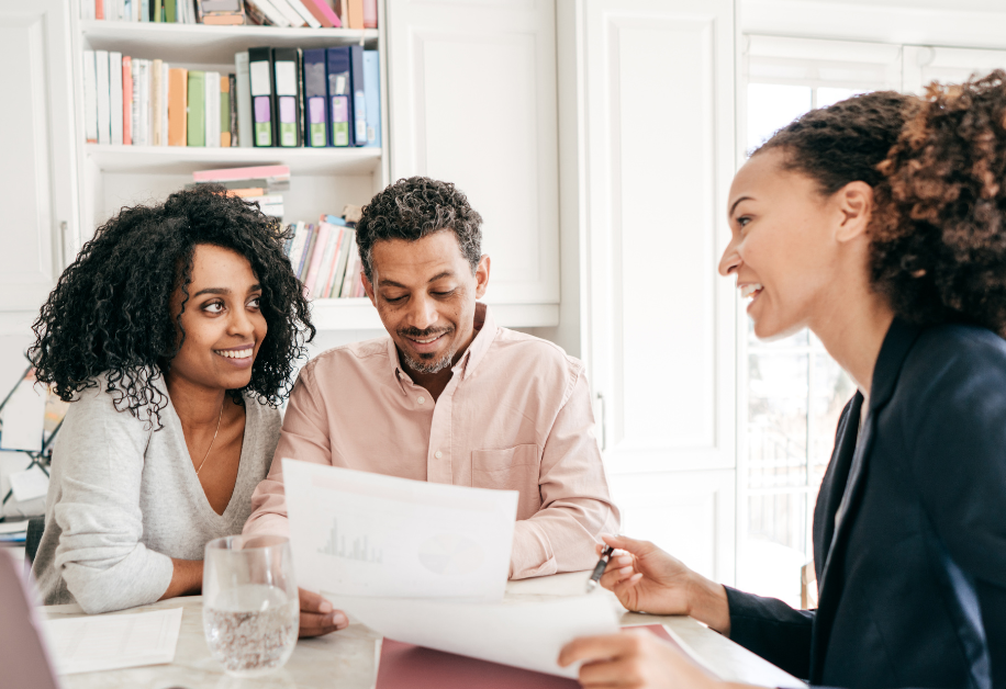About Our Loans A couple speaking with a small business loan specialist